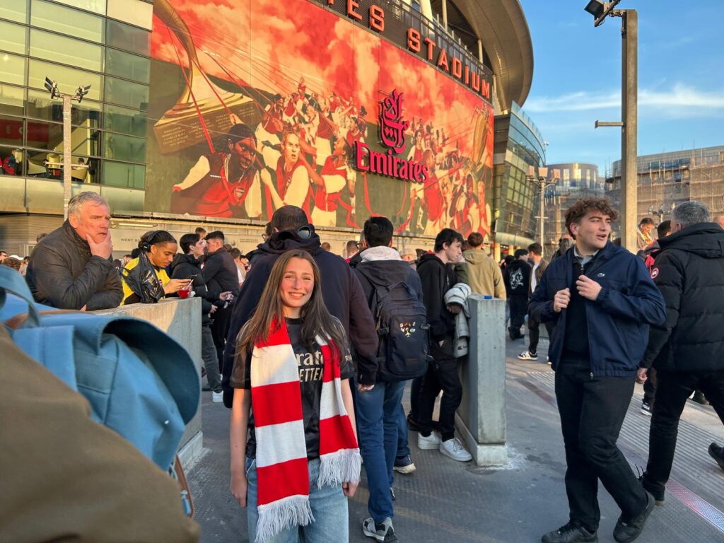 Outside Arsenal Football Club visiting London with teens